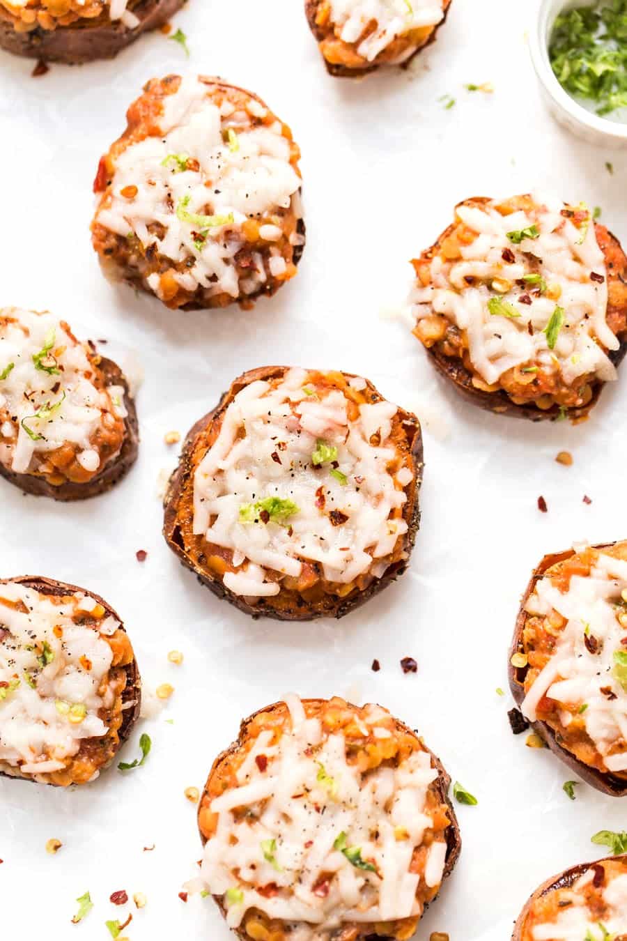 vegan sweet potato pizza bites topped with lentil bolognese sauce