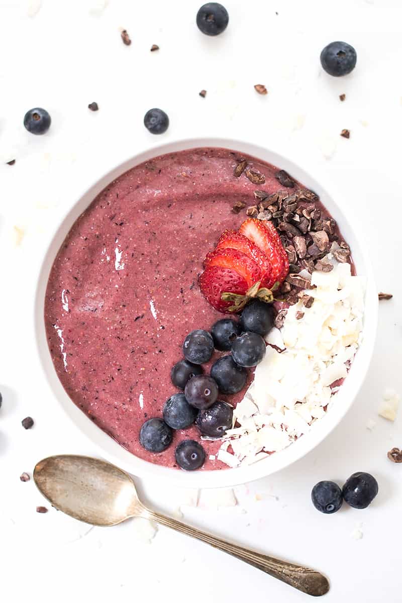 BERRY BLISS Smoothie Bowl topped with coconut, cacao nibs, blueberries and sliced strawberries!