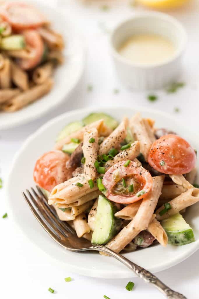 This CREAMY Mediterranean Pasta Salad is made with a delicious sauce and packed with veggies!