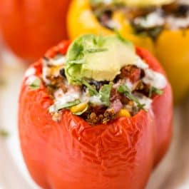MEXICAN QUINOA STUFFED PEPPERS -- with black beans, corn, tomatoes and topped with avocado!