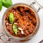 overhead of sun dried tomato pesto in a glass canning jar