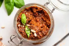 overhead of sun dried tomato pesto in a glass canning jar