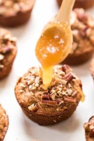Drizzling honey onto blender muffin with applesauce
