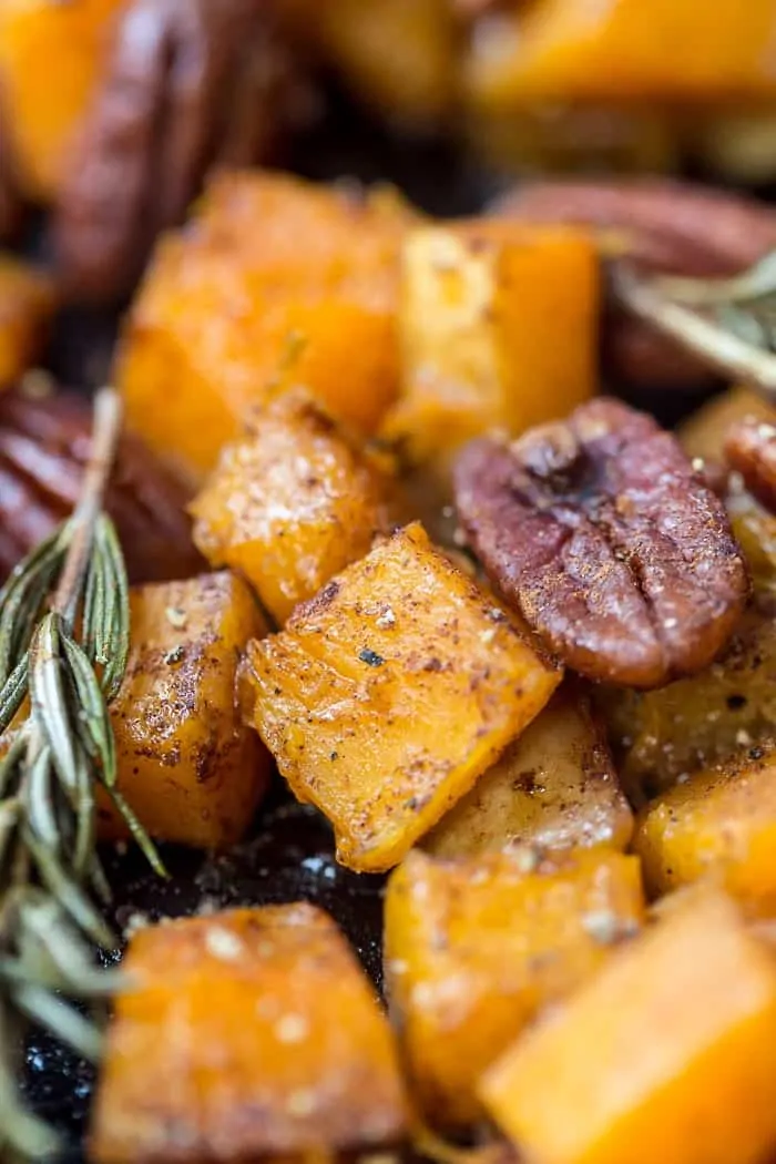 Closeup of roasted butternut squash with pecans and rosemary