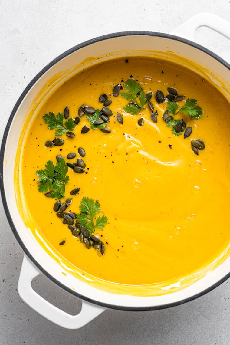 pot of curried cauliflower and squash soup with pumpkin seeds