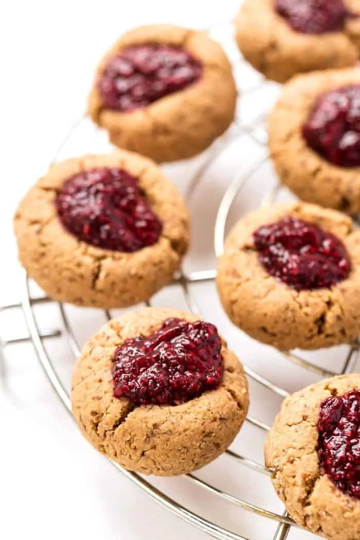 These HEALTHY & Gluten-Free Raspberry Thumbprint Cookies are made with a cashew butter base and topped with homemade raspberry chia seed jam! [VEGAN]