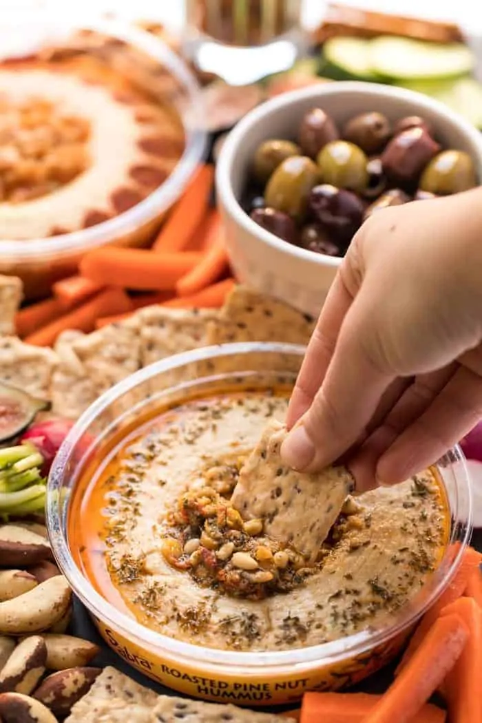 vegan snack board with hummus and olives