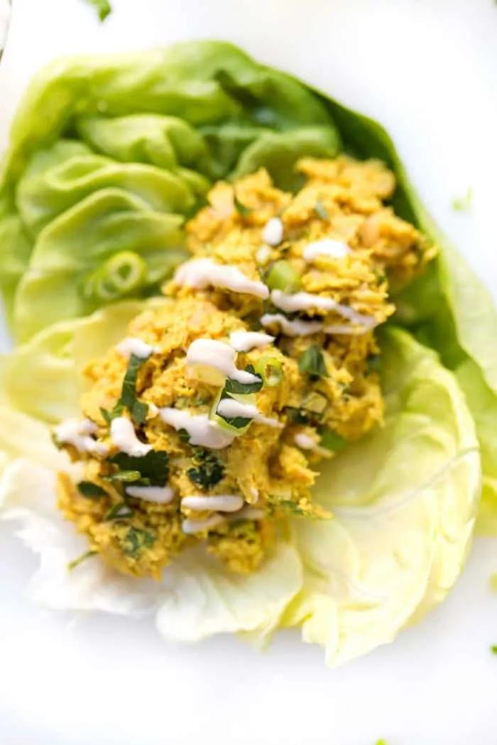 smashed curry chickpea salad served in a lettuce wrap