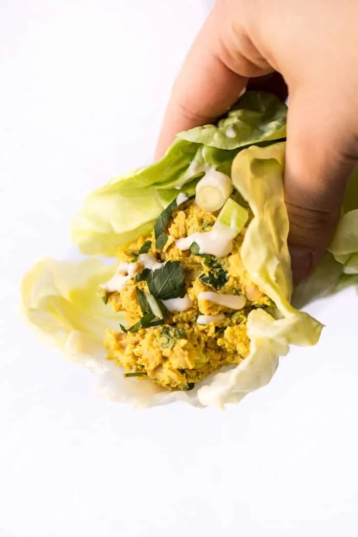smashed curry chickpea salad served in a lettuce wrap