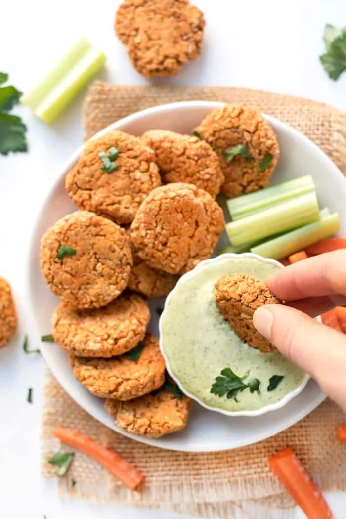 vegan buffalo quinoa bites dipped in vegan ranch dressing