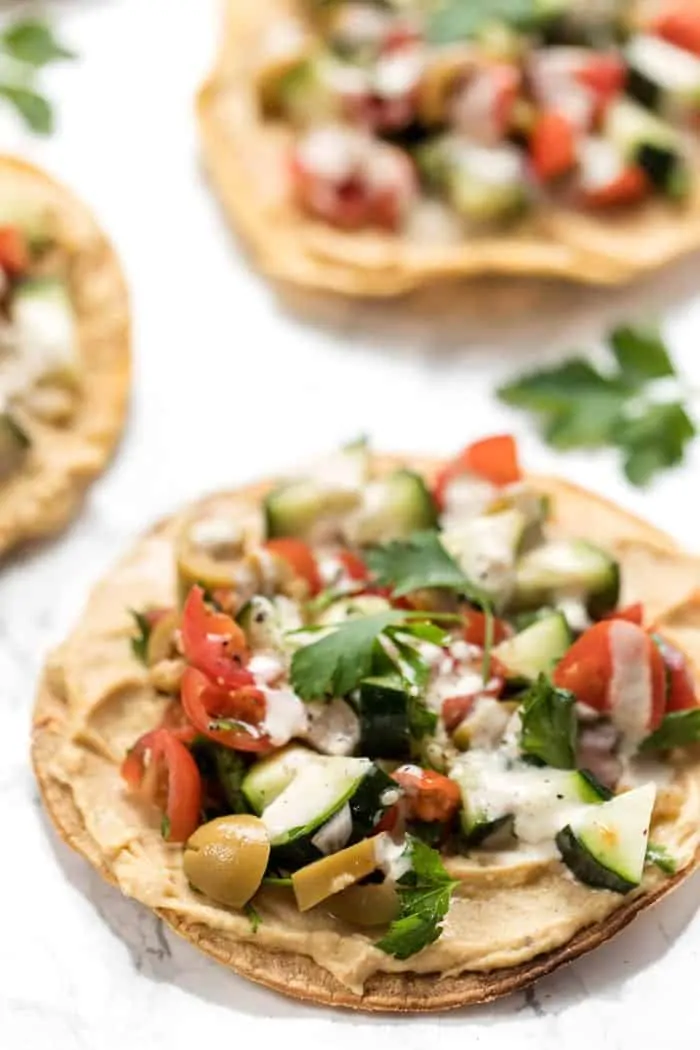 mediterranean tostadas with hummus and greek salad