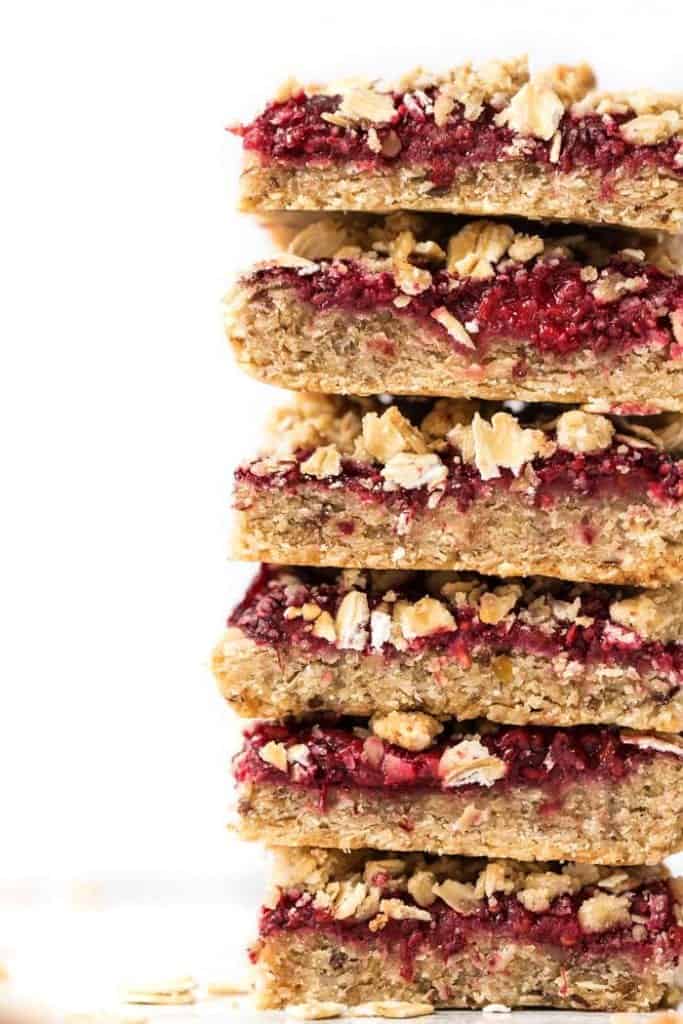 perfect vegan raspberry bars with an oat-almond flour topping