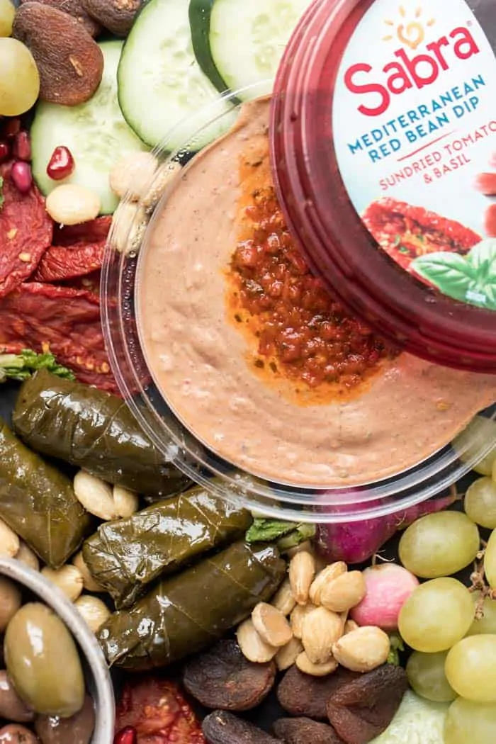 sabra red bean dip on a vegan snack board