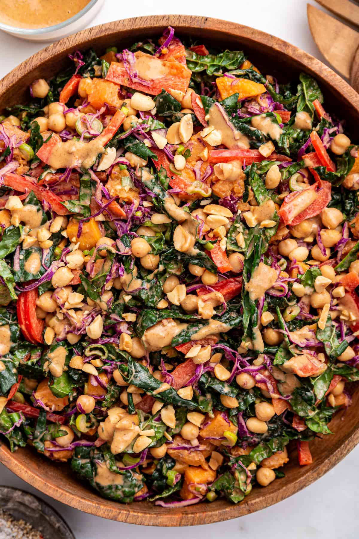 Serving bowl of kale sweet potato salad with creamy Thai dressing