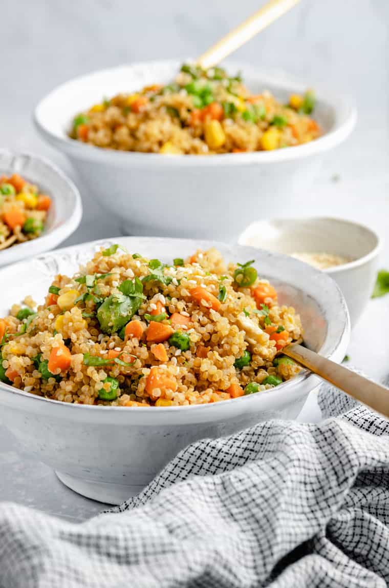 side view of quinoa fried rice with vegetables in a white bowl