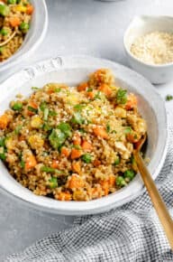 bowl of easy quinoa fried rice from the side with sesame seeds on top