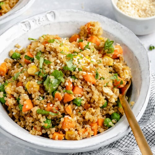 bowl of easy quinoa fried rice from the side with sesame seeds on top