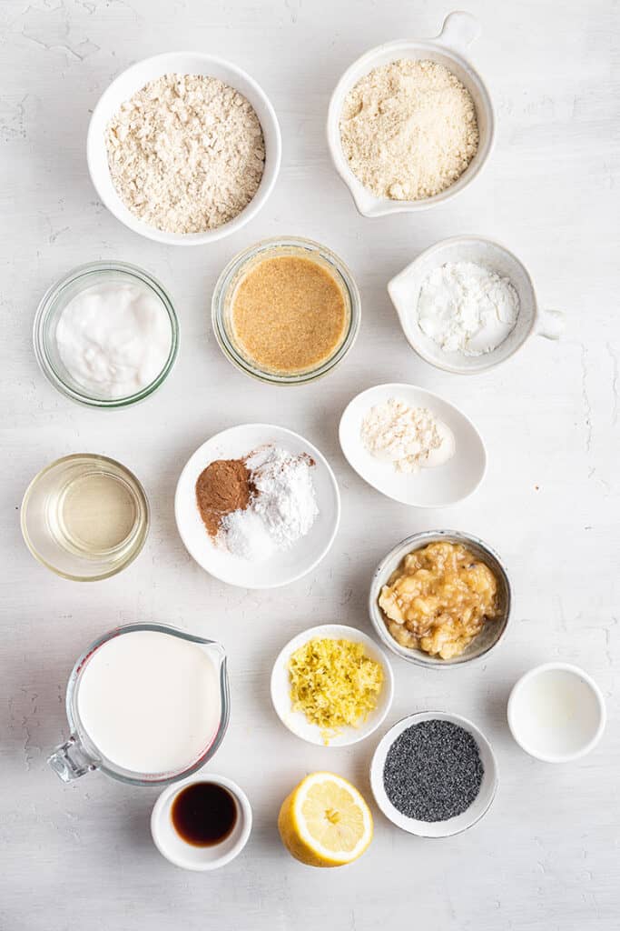 Flour, milk, banana and other ingredients on marble countertop