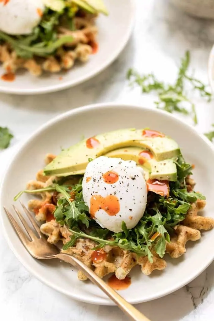savory zucchini almond flour waffles with hummus and poached eggs