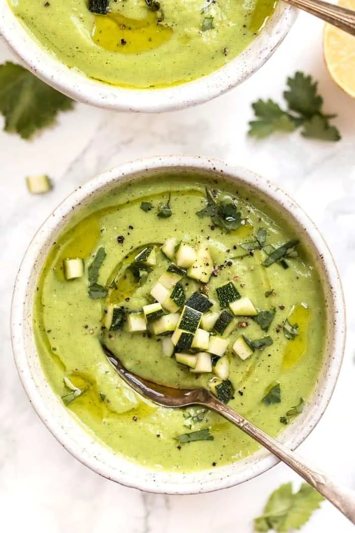 Foods that are high in magnesium are common and delicious, and can help you get all the nutrients your body needs to function. A bowl of avocado and zucchini soup with cubes of zucchini on top, and a spoon in it