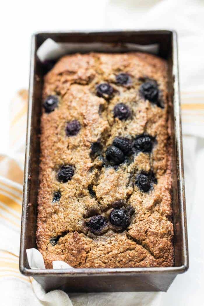 This healthy blueberry banana bread recipe is every bit as delicious as the original, but gluten-free and sweetened without refined sugar! Healthy blueberry banana bread in loaf pan