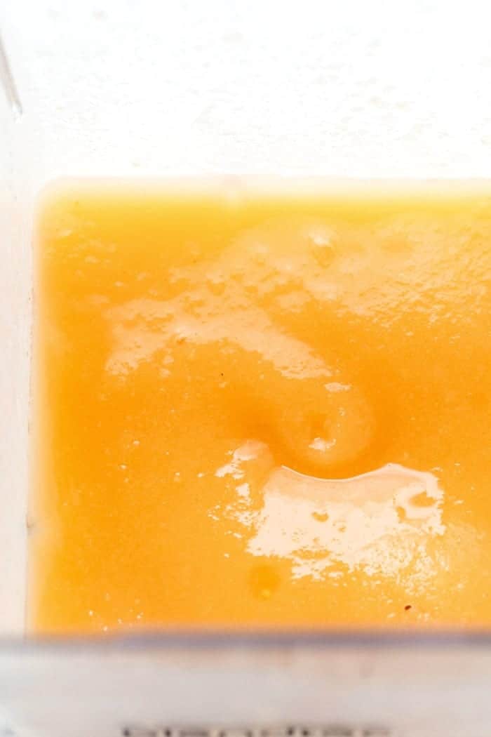 Overhead view of mango peach frose in blender