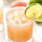 Grapefruit margarita in glass with lime slice on rim