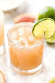 Grapefruit margarita in glass with lime slice on rim