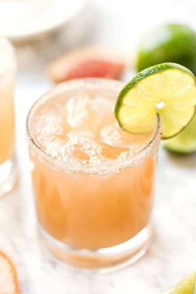 Grapefruit margarita in glass with lime slice on rim