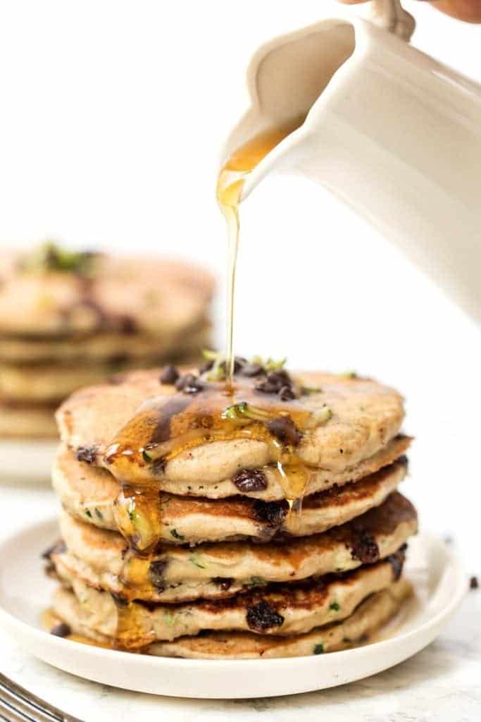 Pouring Maple Syrup on Healthy Pancakes