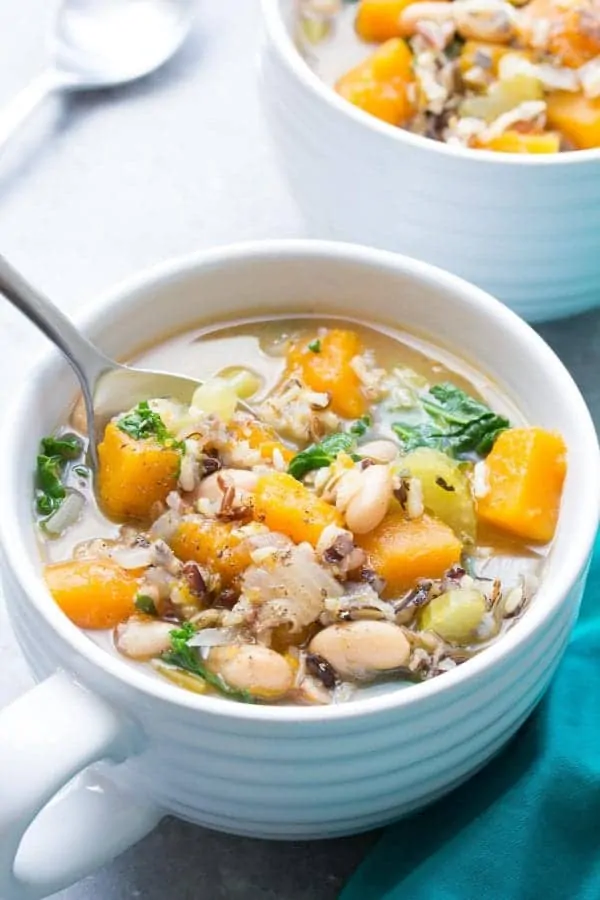 white bowl with wild rice vegetable soup with white beans