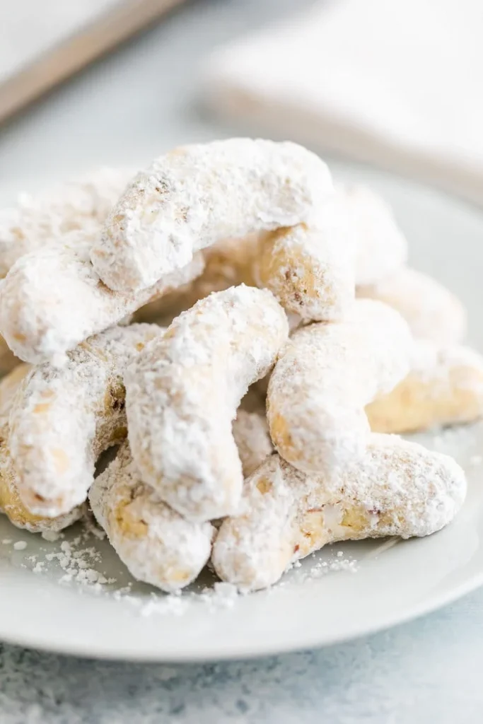 plate of crescent cookies with powdered sugar made with almond flour