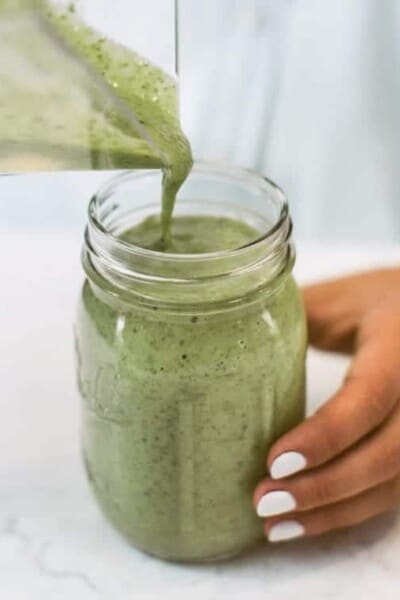 Pouring Green Smoothie Into Mason Jar