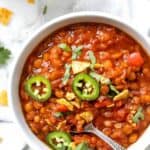 Overhead view of lentil chili in bowl with spoon