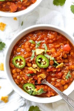 Overhead view of lentil chili in bowl with spoon