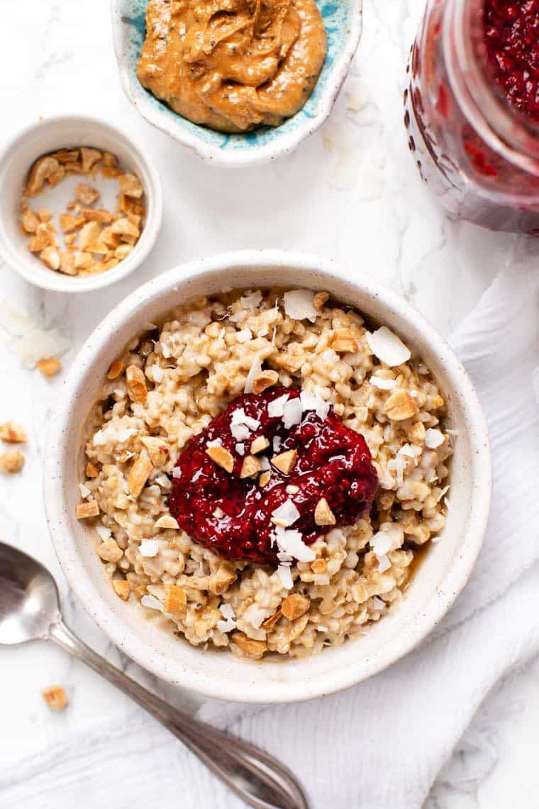 Learn how to make the creamiest steel-cut oats in the Instant Pot. This easy method works every time. Plus, get 6 flavor variations! Peanut Butter & Jelly Steel Cut Oats