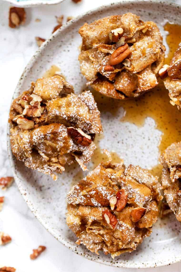This easy French toast muffins recipe is flavored with cinnamon and apple for warm, cozy vibes. A meal prep breakfast you'll feel good about! Overhead view of French toast muffins on plate