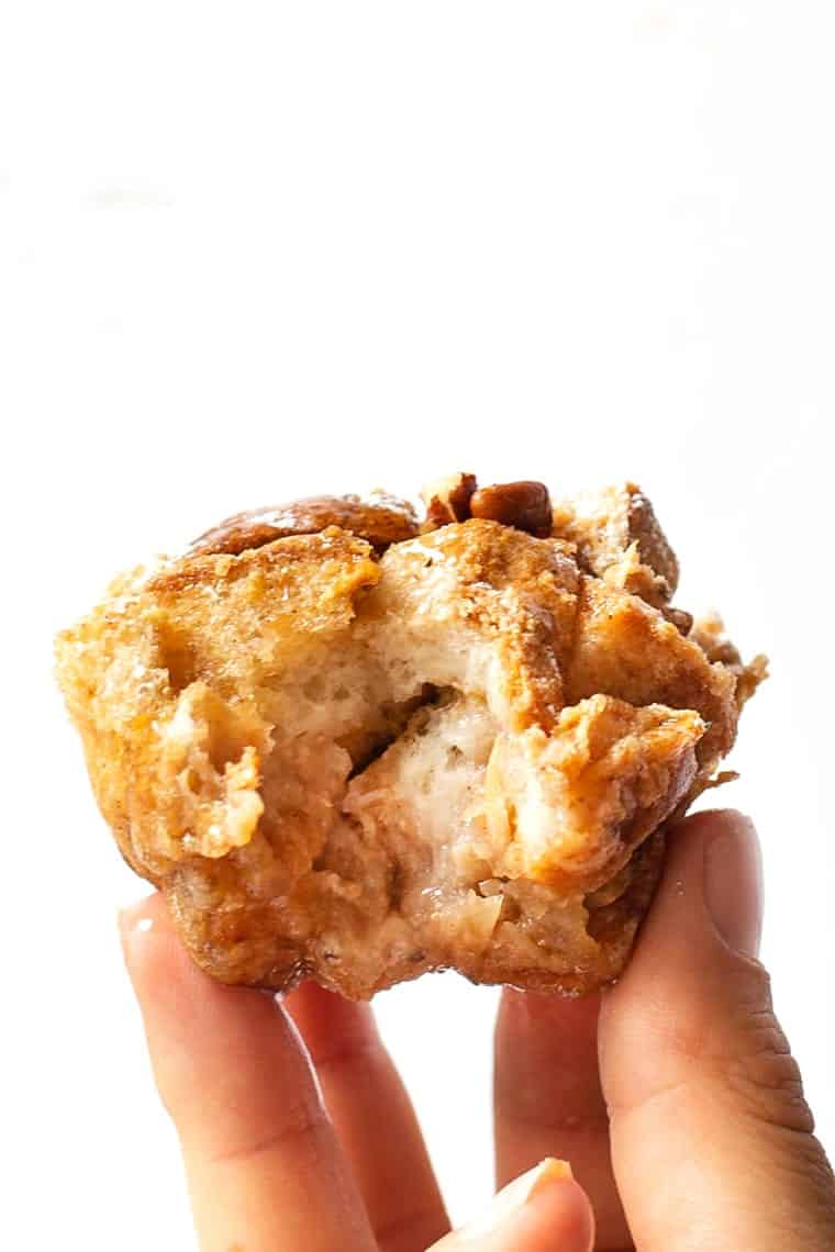 This easy French toast muffins recipe is flavored with cinnamon and apple for warm, cozy vibes. A meal prep breakfast you'll feel good about! Hand holding French toast muffin