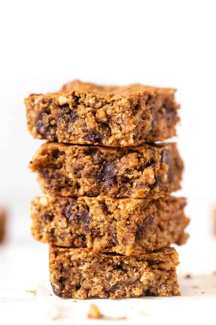 These easy peanut butter oatmeal bars are soft, chewy and jazzed up with chocolate chips. They make an awesome snack or a healthy dessert! Stack of 4 peanut butter oatmeal bars with chocolate chips