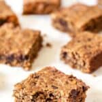Peanut butter oatmeal bars on countertop with one bar bitten