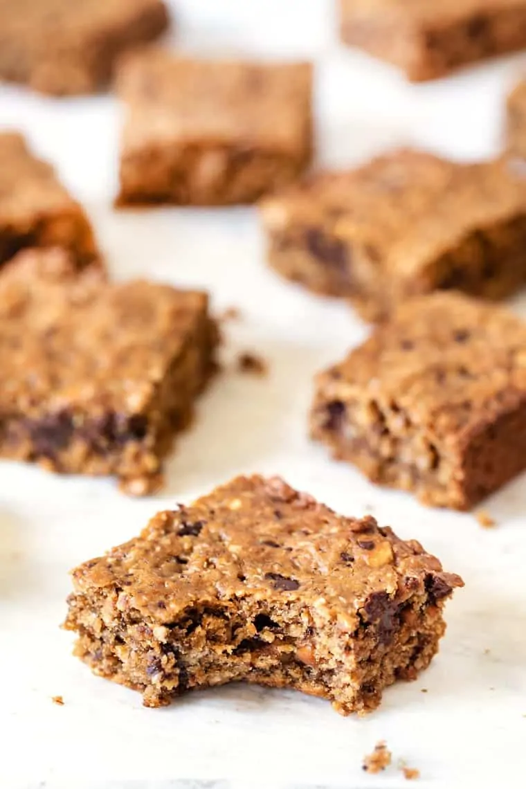 Peanut butter oatmeal bars on countertop with one bar bitten