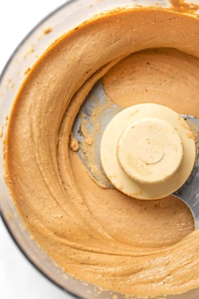 Overhead view of a food processor filled with cashew butter