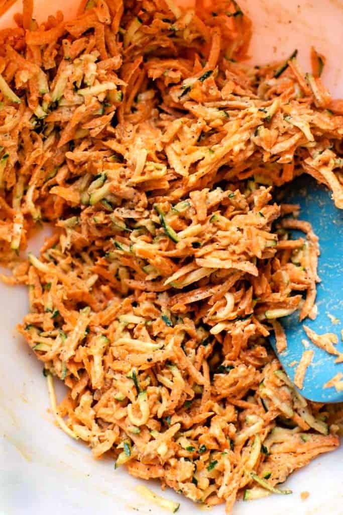 These gluten-free veggie fritters are crispy, tender and packed with sweet potato, carrots and zucchini for a quick, healthy side or snack! Stirring mixture for veggie fritters.