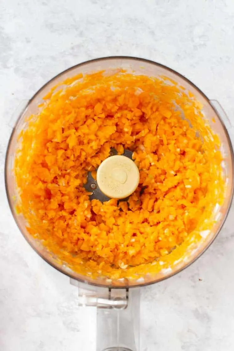 Overhead view of butternut squash burger ingredients blended in a food processor.