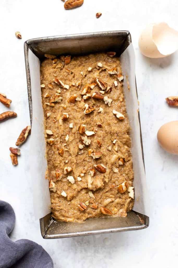 This gluten-free apple banana bread recipe is made with high-protein almond and quinoa flours, apples, and cinnamon for a cozy fall treat! Apple banana bread batter in a loaf pan.