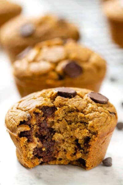 Closeup of vegan pumpkin chocolate chip muffin with bite taken out