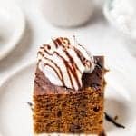 Gingerbread cake on white plate with coconut yogurt and molasses