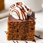 Gluten-free gingerbread cake topped with coconut yogurt and molasses drizzle
