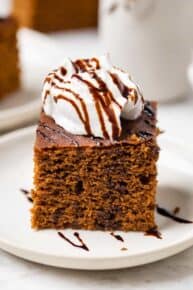 Gluten-free gingerbread cake topped with coconut yogurt and molasses drizzle