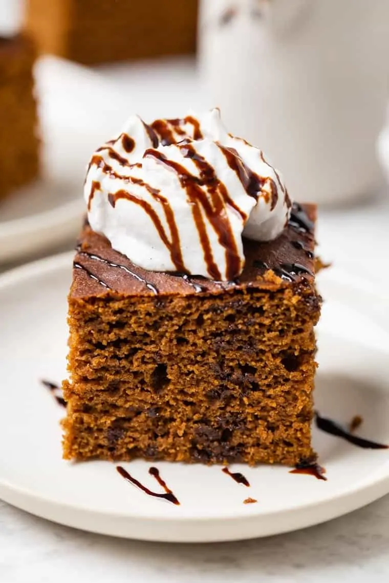 Gluten-free gingerbread cake topped with coconut yogurt and molasses drizzle